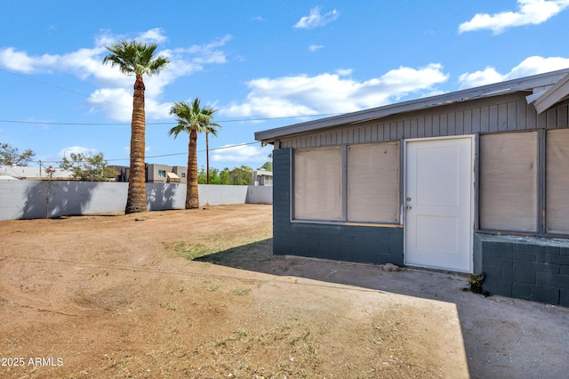 view of outbuilding featuring fence
