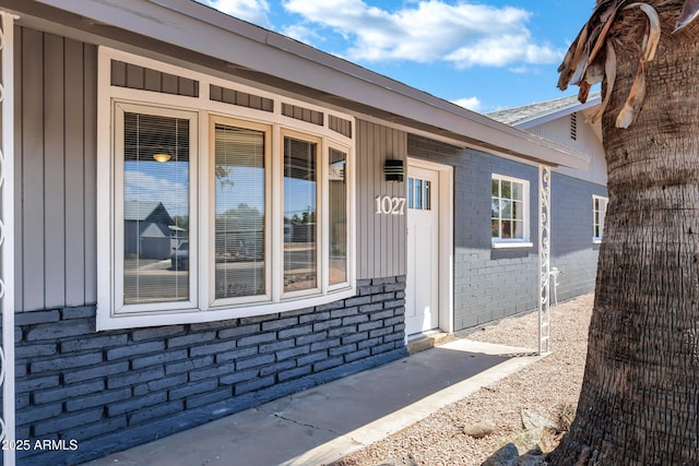 property entrance featuring brick siding