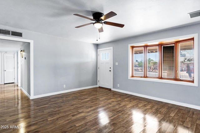 unfurnished room featuring baseboards, ceiling fan, visible vents, and wood finished floors
