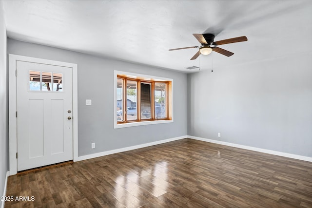 foyer entrance featuring ceiling fan, visible vents, dark wood-style floors, and baseboards