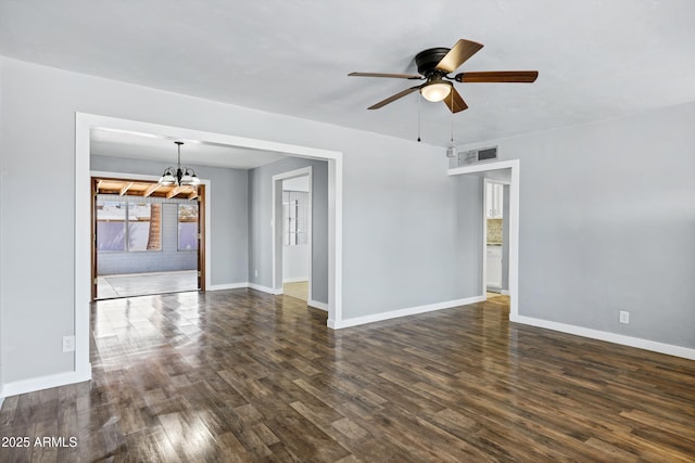 unfurnished room with baseboards, ceiling fan with notable chandelier, dark wood-style flooring, and visible vents