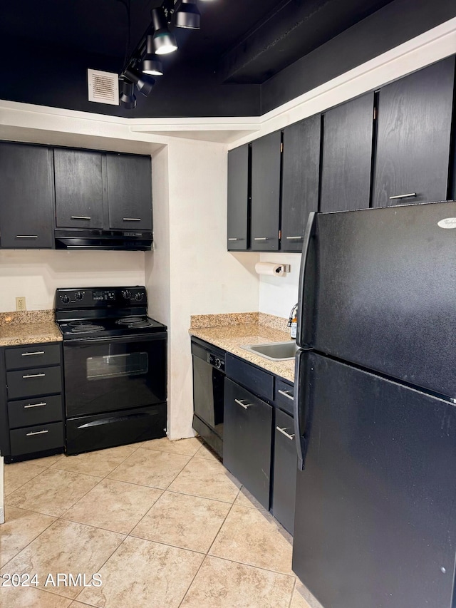 kitchen featuring black appliances, sink, and light tile patterned flooring