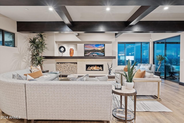 living room with beam ceiling and light wood-type flooring