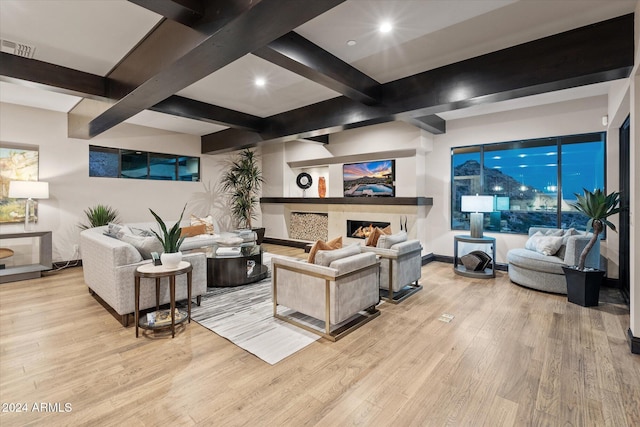 living room featuring beamed ceiling and light wood-type flooring