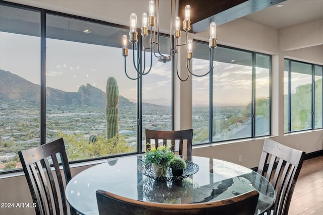 dining area featuring a mountain view, hardwood / wood-style floors, and a chandelier