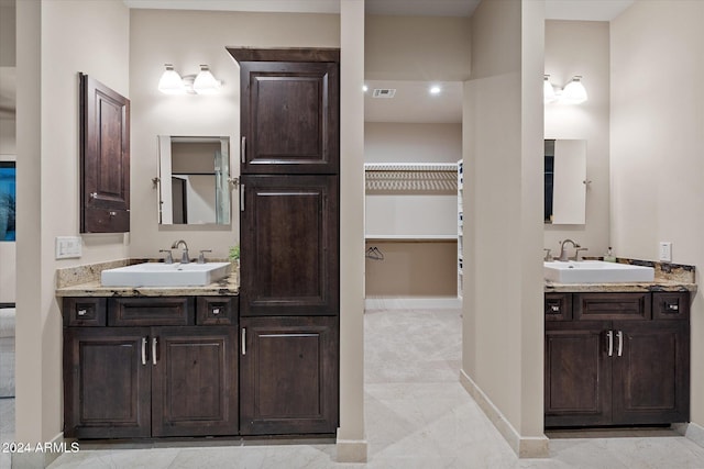 bathroom featuring tile patterned flooring and vanity