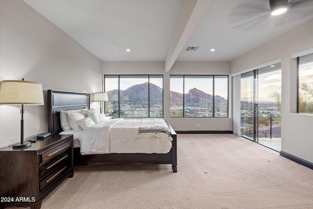 bedroom with access to outside, light colored carpet, ceiling fan, beam ceiling, and a mountain view