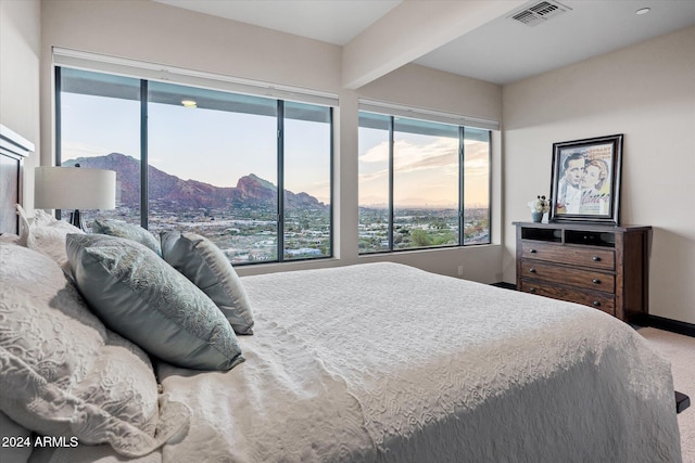 carpeted bedroom with a mountain view and beam ceiling