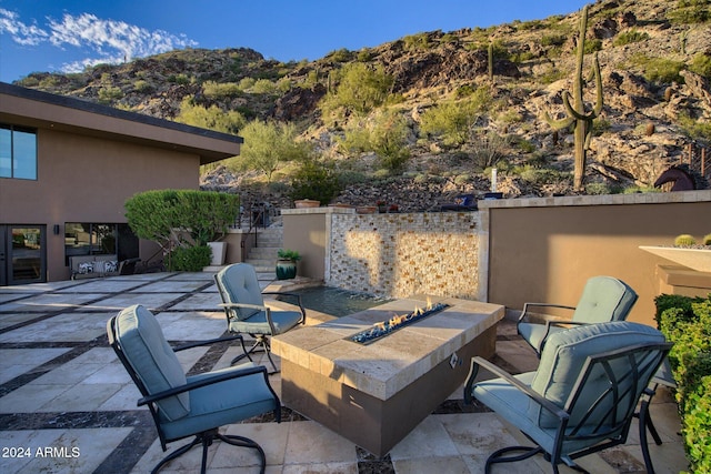 view of patio / terrace featuring a mountain view and a fire pit