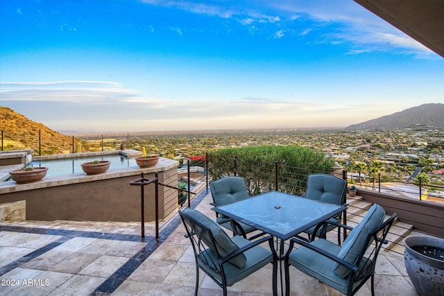 patio terrace at dusk with a mountain view