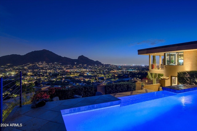 pool at dusk with a mountain view