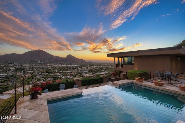 pool at dusk with a mountain view