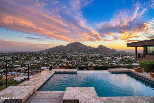 pool at dusk with a mountain view