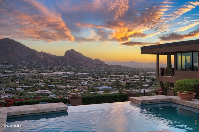 pool at dusk with a mountain view