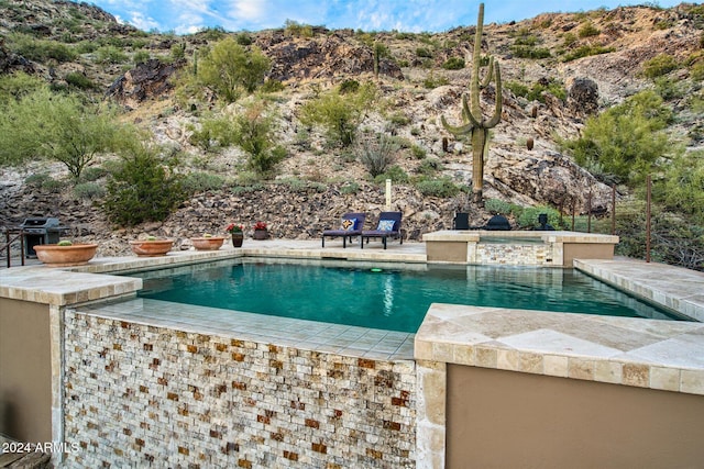 view of pool with grilling area