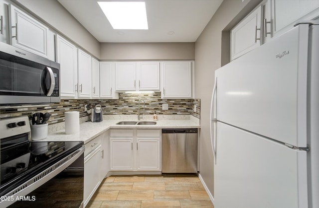 8141 N Central Ave Unit 9, Phoenix, AZ 85020 - kitchen featuring appliances with stainless steel finishes, a sink, white cabinetry, and backsplash