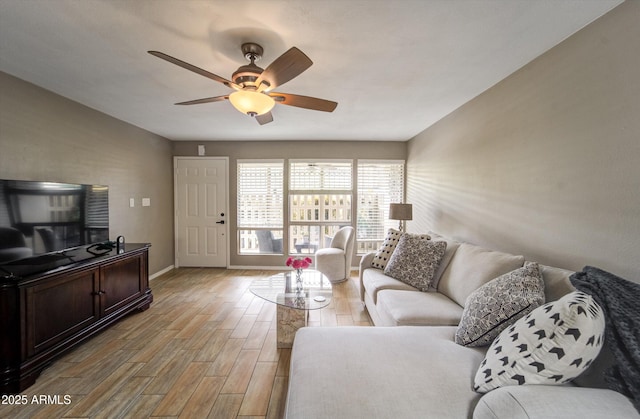 8141 N Central Ave Unit 9, Phoenix, AZ 85020 - living area with light wood-style flooring, a ceiling fan, and baseboards