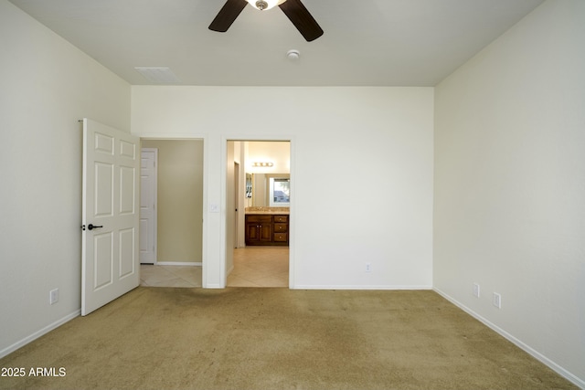 unfurnished bedroom with visible vents, baseboards, light colored carpet, and a ceiling fan