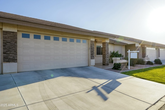 view of front facade with concrete driveway, a garage, and stone siding