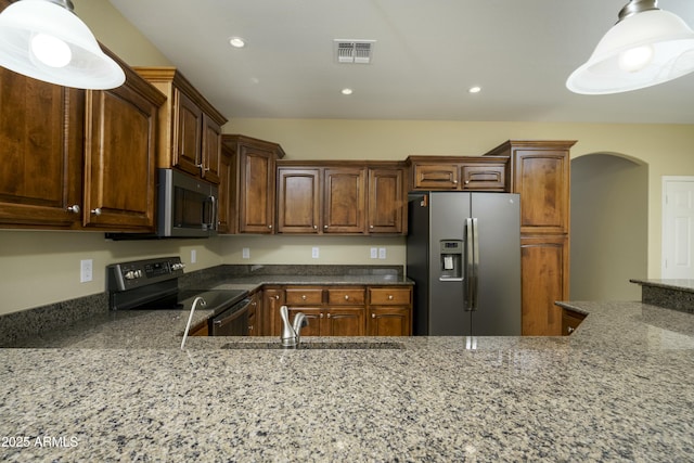 kitchen featuring visible vents, dark stone counters, recessed lighting, appliances with stainless steel finishes, and a sink