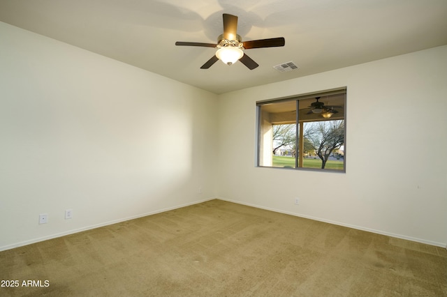 carpeted spare room with visible vents and baseboards