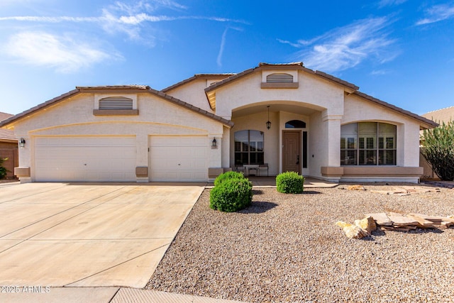 2230 E Whitten St, Chandler, AZ 85225 - mediterranean / spanish house featuring an attached garage, driveway, and stucco siding