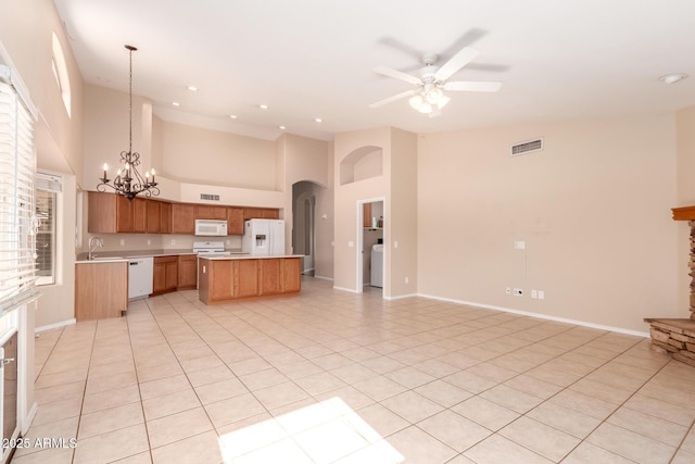 2230 E Whitten St, Chandler, AZ 85225 - kitchen with white appliances, open floor plan, arched walkways, a chandelier, and light countertops