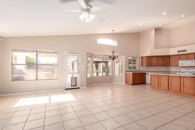 2230 E Whitten St, Chandler, AZ 85225 - kitchen featuring white appliances, a chandelier, light countertops, brown cabinetry, and high vaulted ceiling