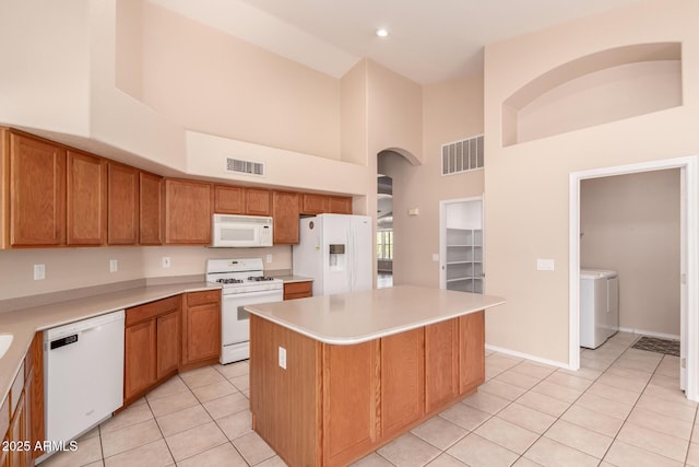 2230 E Whitten St, Chandler, AZ 85225 - kitchen featuring white appliances, high vaulted ceiling, light tile patterned floors, arched walkways, and a center island