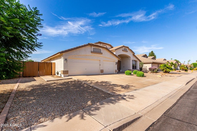 2230 E Whitten St, Chandler, AZ 85225 - mediterranean / spanish-style home featuring a garage, stucco siding, concrete driveway, and a gate