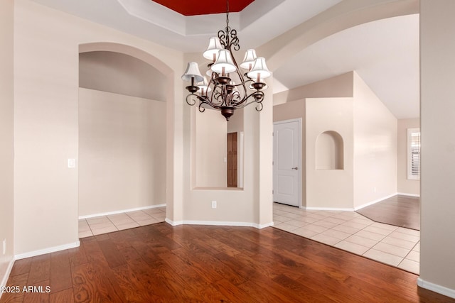 2230 E Whitten St, Chandler, AZ 85225 - unfurnished room with wood finished floors, a chandelier, and arched walkways