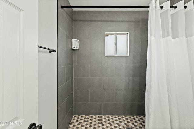 full bath featuring a tile shower