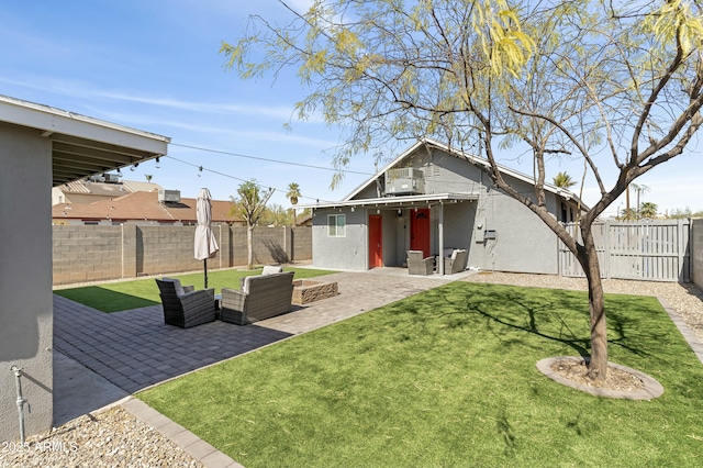 view of yard featuring a patio area, a fenced backyard, an outdoor living space, and central air condition unit