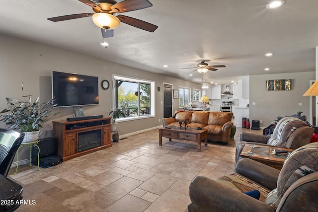 1185 S Camino Cobre Dr, Wickenburg, AZ 85390 - living room featuring recessed lighting, baseboards, a ceiling fan, and stone tile flooring