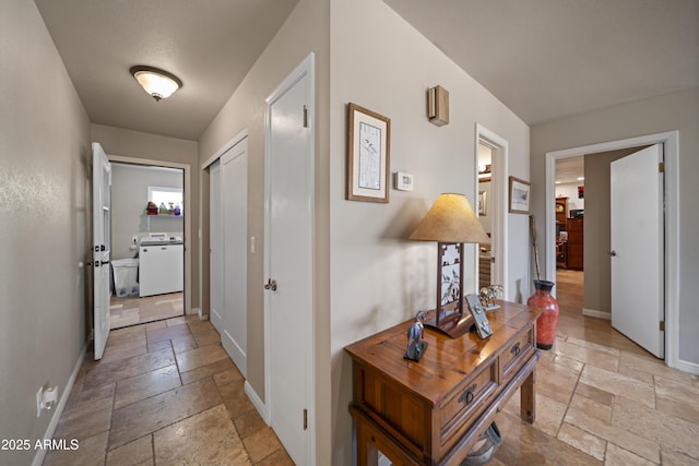 1185 S Camino Cobre Dr, Wickenburg, AZ 85390 - corridor with stone tile floors, baseboards, and washer / clothes dryer