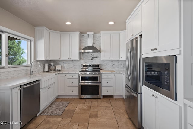 1185 S Camino Cobre Dr, Wickenburg, AZ 85390 - kitchen with recessed lighting, white cabinetry, decorative backsplash, wall chimney range hood, and appliances with stainless steel finishes