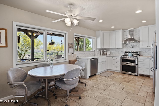 1185 S Camino Cobre Dr, Wickenburg, AZ 85390 - kitchen featuring wall chimney exhaust hood, stainless steel appliances, tasteful backsplash, and recessed lighting