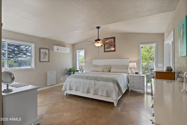 1185 S Camino Cobre Dr, Wickenburg, AZ 85390 - tiled bedroom featuring a wall unit AC, a textured ceiling, baseboards, ceiling fan, and lofted ceiling