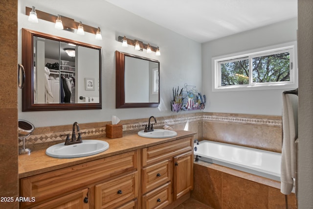 1185 S Camino Cobre Dr, Wickenburg, AZ 85390 - bathroom with a sink, double vanity, a spacious closet, and a garden tub