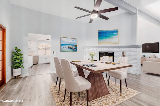 3315 E Hampton Ave, Mesa, AZ 85204 - dining area featuring light wood-style floors, a ceiling fan, a brick fireplace, and high vaulted ceiling