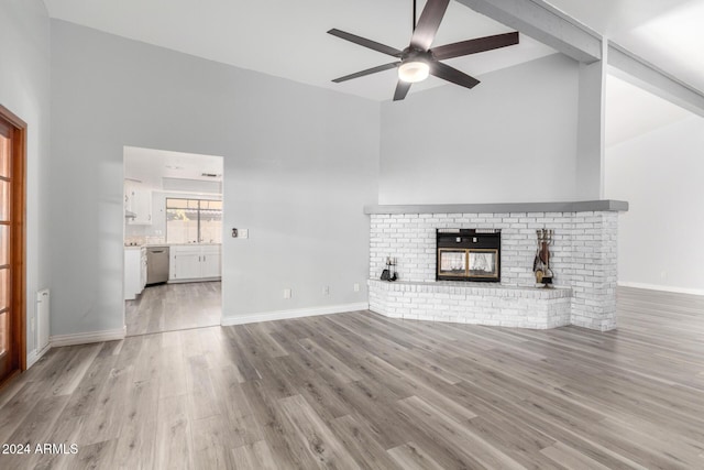 3315 E Hampton Ave, Mesa, AZ 85204 - unfurnished living room featuring a ceiling fan, lofted ceiling, light wood-type flooring, and a brick fireplace