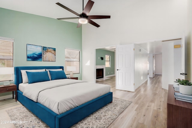 3315 E Hampton Ave, Mesa, AZ 85204 - bedroom featuring a high ceiling, light wood finished floors, a high end fireplace, and a ceiling fan