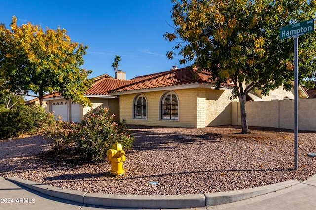 3315 E Hampton Ave, Mesa, AZ 85204 - view of front of house with a tile roof, a garage, a chimney, and stucco siding
