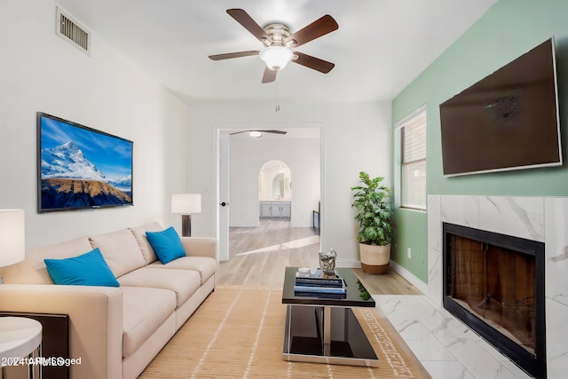 3315 E Hampton Ave, Mesa, AZ 85204 - living room with ceiling fan, a high end fireplace, arched walkways, and marble finish floors