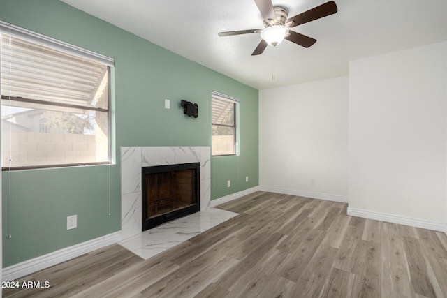 3315 E Hampton Ave, Mesa, AZ 85204 - unfurnished living room with wood finished floors, a high end fireplace, and a ceiling fan