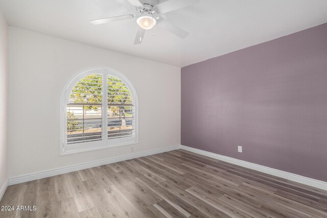 3315 E Hampton Ave, Mesa, AZ 85204 - empty room with wood finished floors and a ceiling fan