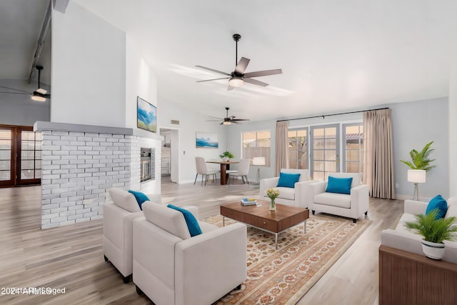 3315 E Hampton Ave, Mesa, AZ 85204 - living area featuring vaulted ceiling, light wood-type flooring, a fireplace, and ceiling fan