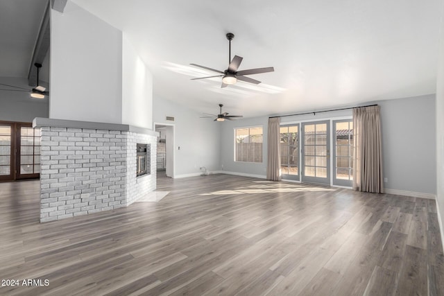 3315 E Hampton Ave, Mesa, AZ 85204 - unfurnished living room with lofted ceiling, a brick fireplace, wood finished floors, and a ceiling fan