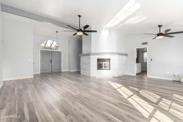 3315 E Hampton Ave, Mesa, AZ 85204 - unfurnished living room with ceiling fan, a fireplace, light wood-type flooring, and lofted ceiling