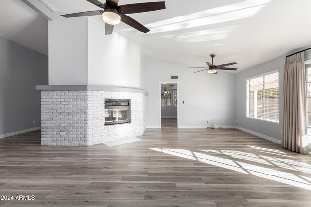 3315 E Hampton Ave, Mesa, AZ 85204 - unfurnished living room with a ceiling fan, lofted ceiling, a brick fireplace, and wood finished floors